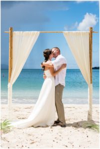 bride and groom kissing at their wedding on the island